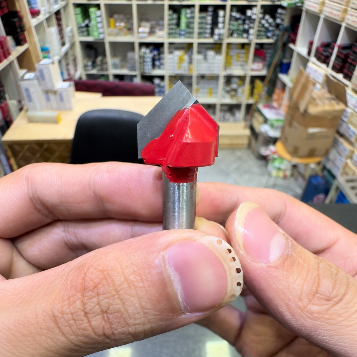 Pointed V-groove router bit held in hand